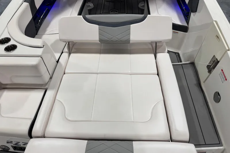 Slide: The Image of 2020 Chaparral 287 SSX boat interior with white cushioned seating and cup holders. - 7