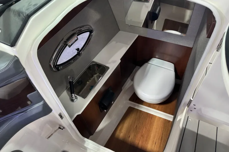 Slide: The Image of Chaparral 287 SSX 2020 boat interior with compact bathroom and modern amenities. - 8