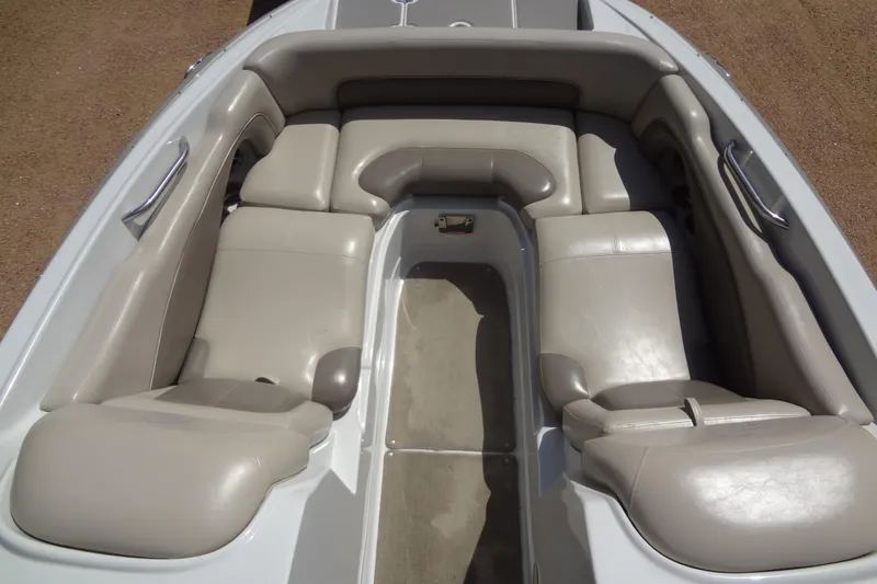 Slide: The Image of 2013 Crownline Eclipse E4 boat interior with beige seating and stainless steel handles. - 11