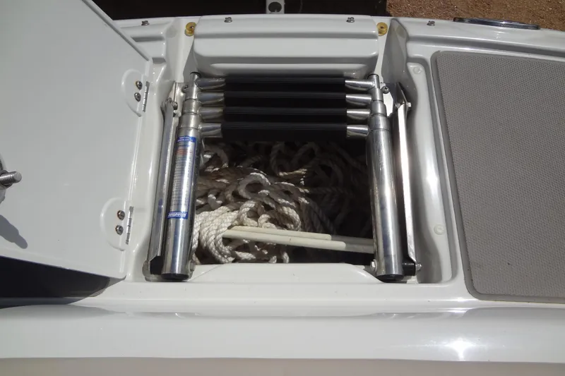 Slide: The Image of 2013 Crownline Eclipse E4 boat storage compartment with ropes and hydraulic lift. - 15