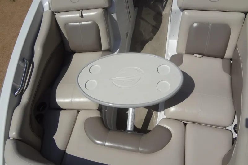 Slide: The Image of 2013 Crownline Eclipse E4 boat interior with beige seating and oval table. - 17