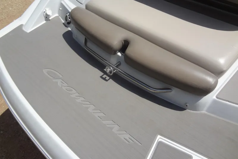 Slide: The Image of 2013 Crownline Eclipse E4 boat deck with cushioned seating and branded flooring. - 18