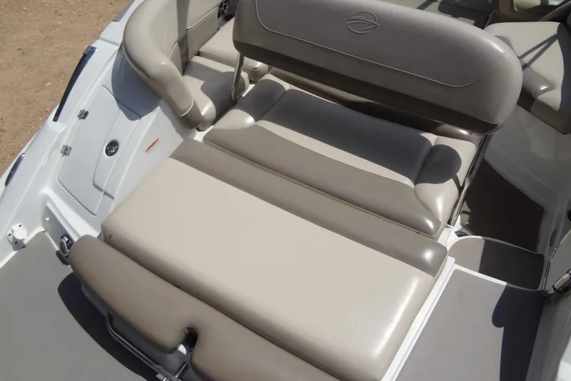 Slide: The Image of 2013 Crownline Eclipse E4 boat interior with beige seating and storage compartments. - 20