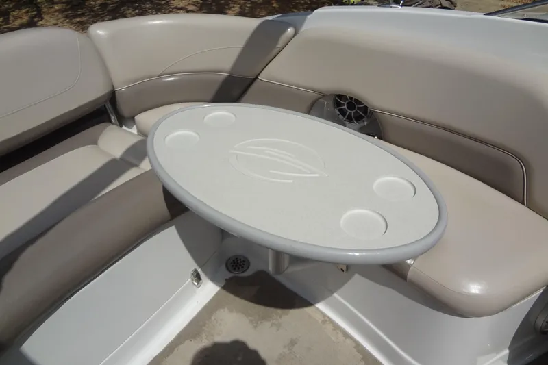 Slide: The Image of 2013 Crownline Eclipse E4 boat interior with beige seating and oval table. - 26