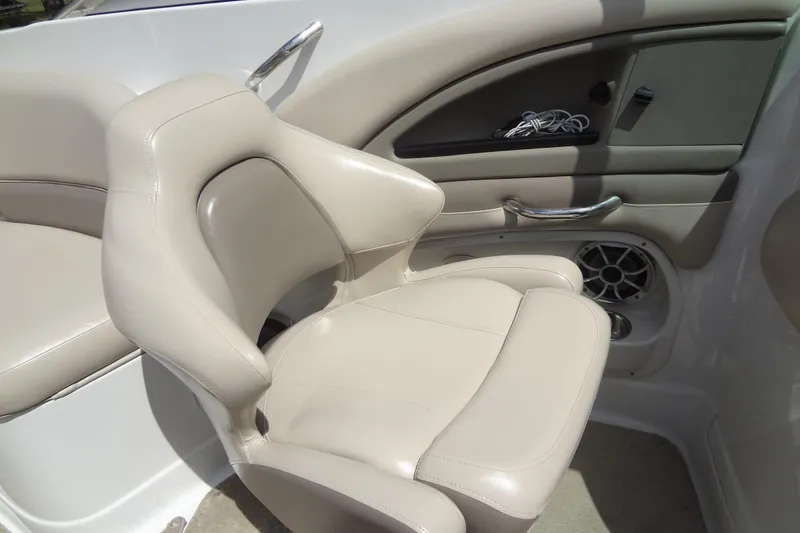 Slide: The Image of 2013 Crownline Eclipse E4 boat interior with beige leather seating and speaker. - 28