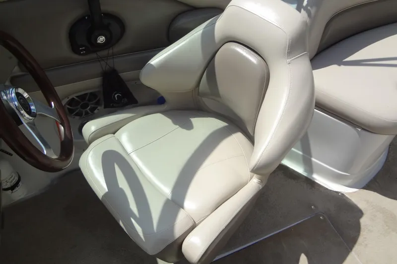 Slide: The Image of 2013 Crownline Eclipse E4 boat interior with beige leather seating and steering wheel. - 31