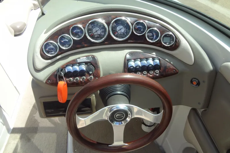 Slide: The Image of Dashboard of 2013 Crownline Eclipse E4 boat with gauges and steering wheel. - 32