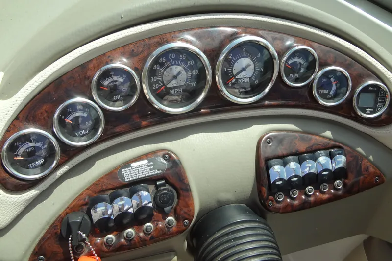 Slide: The Image of Dashboard of a 2013 Crownline Eclipse E4 boat with gauges and controls. - 33
