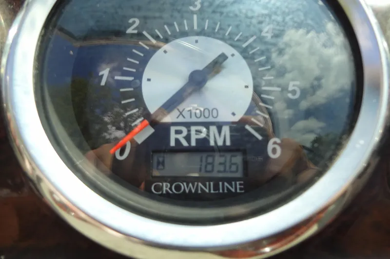 Slide: The Image of Close-up of a 2013 Crownline Eclipse E4 RPM gauge displaying 183.6 hours. - 34