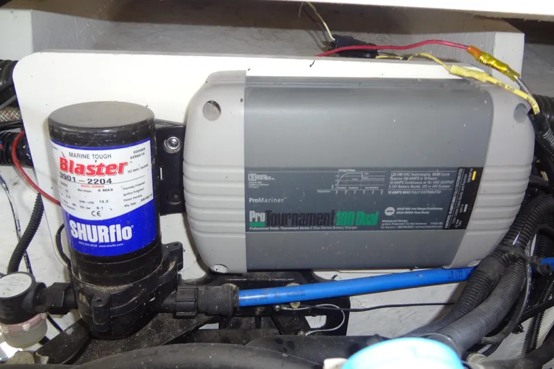 Slide: The Image of Marine equipment in a 2013 Crownline Eclipse E4 boat, featuring a SHURflo pump and ProMariner charger. - 39