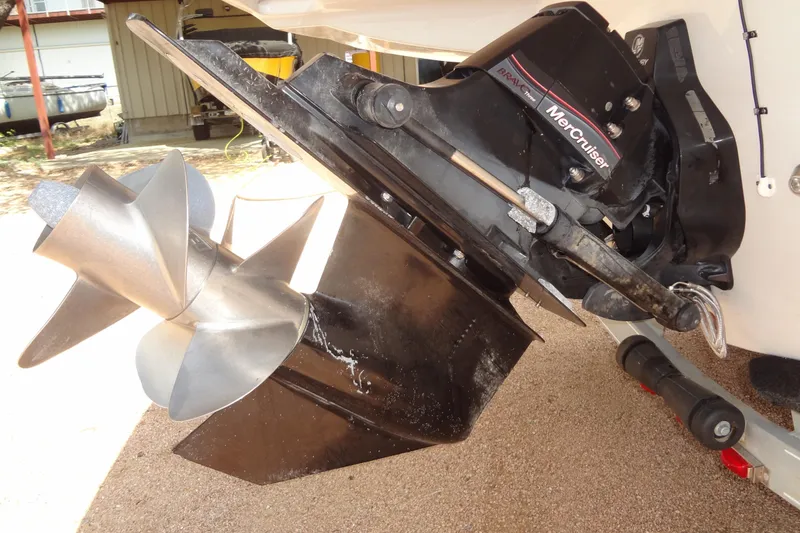 Slide: The Image of 2013 Crownline Eclipse E4 boat with cover, parked outdoors under trees. - 45