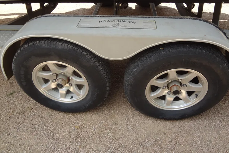 Slide: The Image of 2013 Crownline Eclipse E4 boat interior with beige leather seating and central walkway. - 48