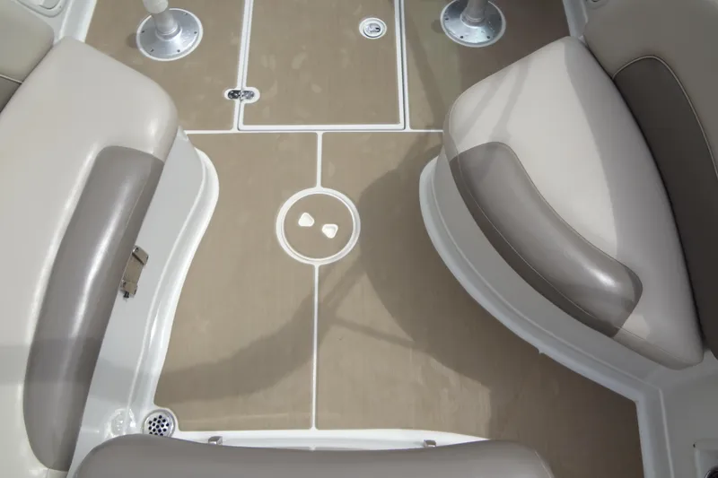 Slide: The Image of 2013 Crownline Eclipse E4 boat interior with beige seating and non-slip flooring. - 50