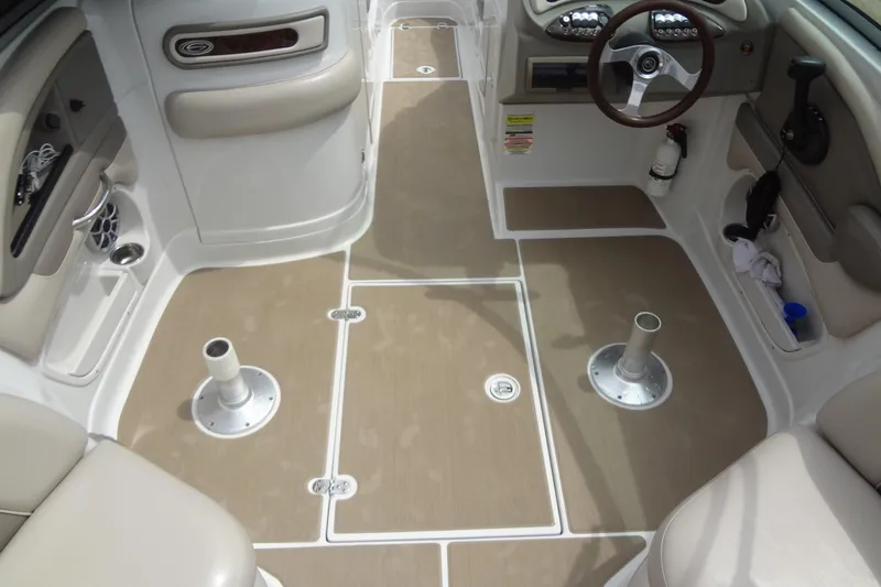 Slide: The Image of 2013 Crownline Eclipse E4 boat interior with beige seating and steering wheel. - 51