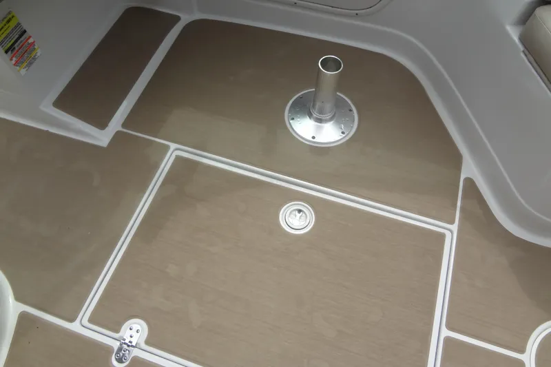 Slide: The Image of 2013 Crownline Eclipse E4 boat deck with wood finish and metal fixture. - 53