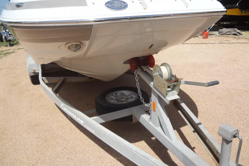 Slide: The Image of 2013 Crownline Eclipse E4 boat on trailer, secured with chain and winch. - 8