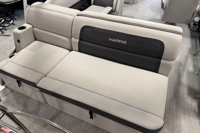 Slide: The Image of 2024 Harris Cruiser 230 boat seating, featuring luxurious beige upholstery and integrated cup holders. - 10
