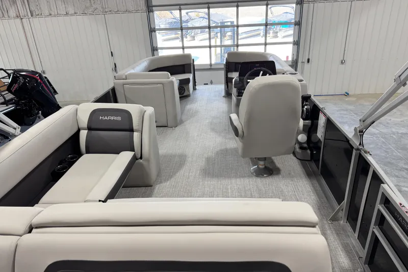 Slide: The Image of 2024 Harris Cruiser 230 pontoon boat interior with plush seating and modern helm. - 11
