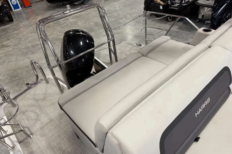 Slide: The Image of 2024 Harris Cruiser 230 boat interior with seating and motor, showcasing luxury design. - 12