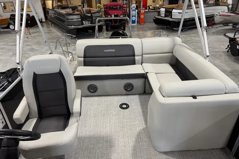 Slide: The Image of 2024 Harris Cruiser 230 pontoon boat interior with plush seating and modern design. - 13