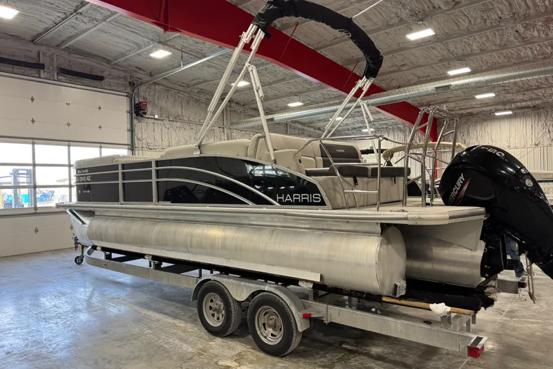 Slide: The Image of 2024 Harris Cruiser 230 pontoon boat on trailer in indoor storage facility. - 3