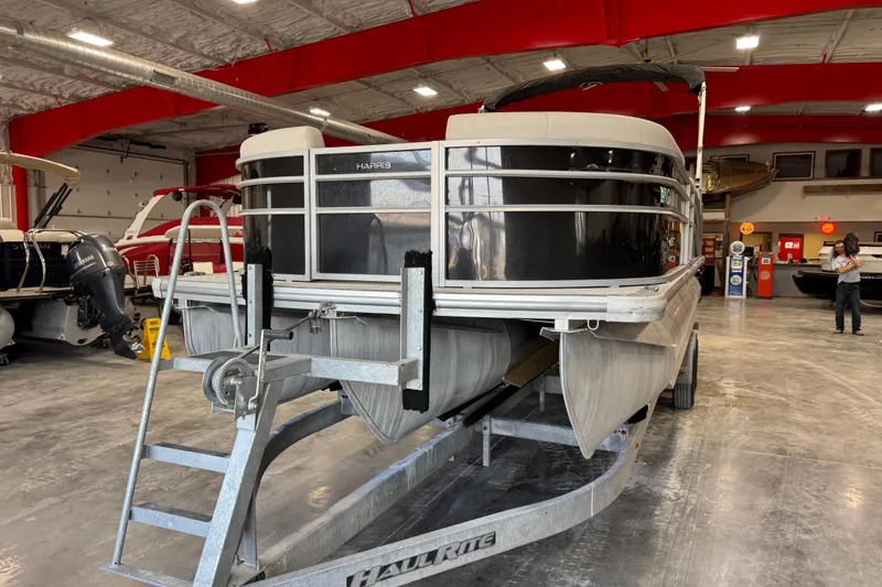 Slide: The Image of 2024 Harris Cruiser 230 pontoon boat on trailer in showroom. - 4