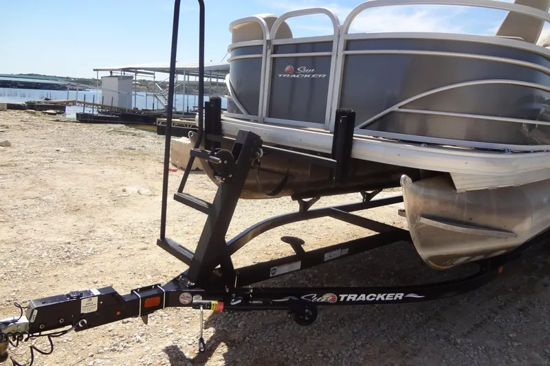 Slide: The Image of 2022 TRACKER MARINE Party Barge 24 DLX on trailer by lakeside. - 12