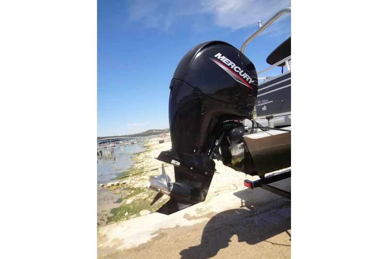 Slide: The Image of 2022 TRACKER MARINE Party Barge 24 DLX with Mercury outboard motor by the shore. - 15