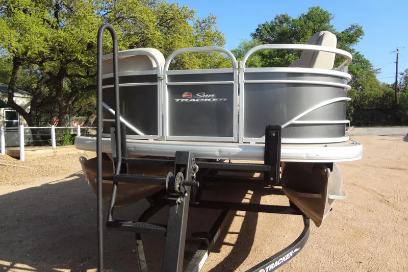 Slide: The Image of 2022 TRACKER MARINE Party Barge 24 DLX pontoon boat on trailer. - 18