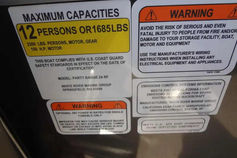 Slide: The Image of 2022 Tracker Marine Party Barge 24 DLX capacity and safety warning labels. - 35