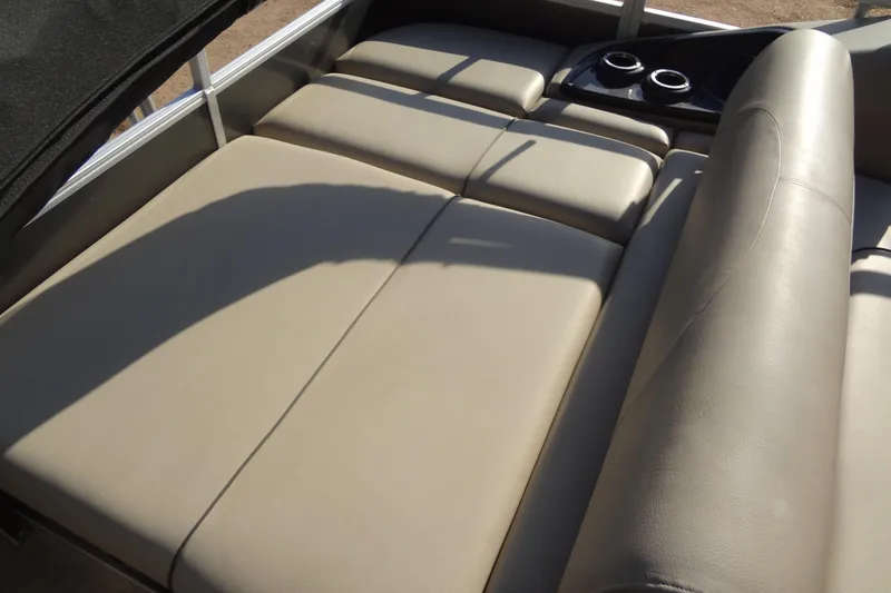 Slide: The Image of 2022 TRACKER MARINE Party Barge 24 DLX with beige cushioned seating and cup holders. - 37