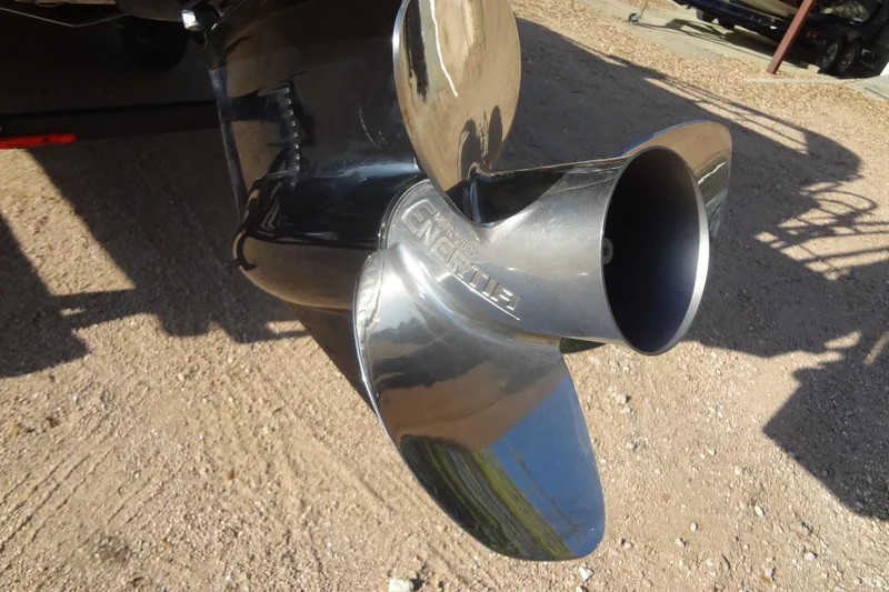 Slide: The Image of Propeller of 2022 TRACKER MARINE Party Barge 24 DLX on gravel surface. - 46