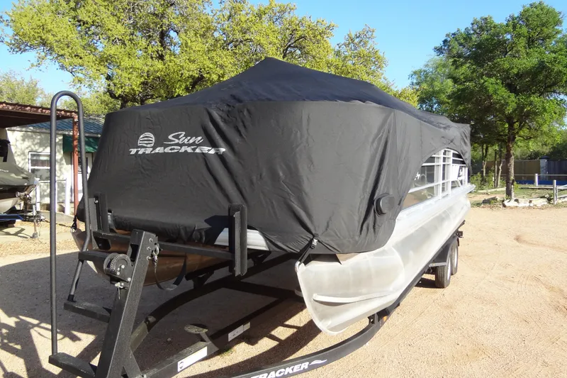 Slide: The Image of 2022 TRACKER MARINE Party Barge 24 DLX covered on trailer outdoors. - 47