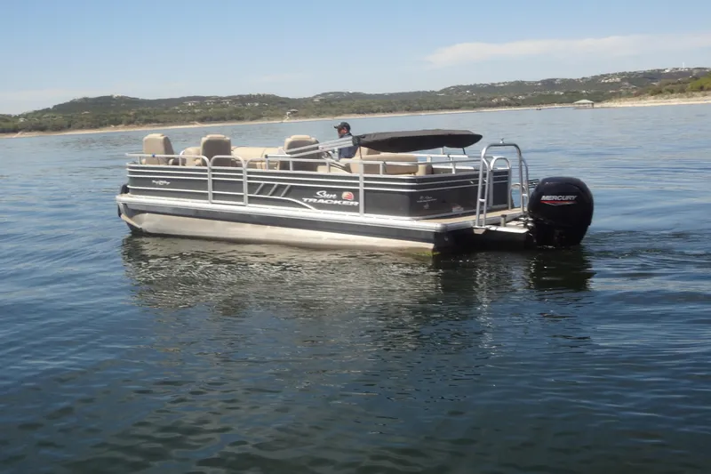 Slide: The Image of 2022 TRACKER MARINE Party Barge 24 DLX pontoon boat on a serene lake. - 5