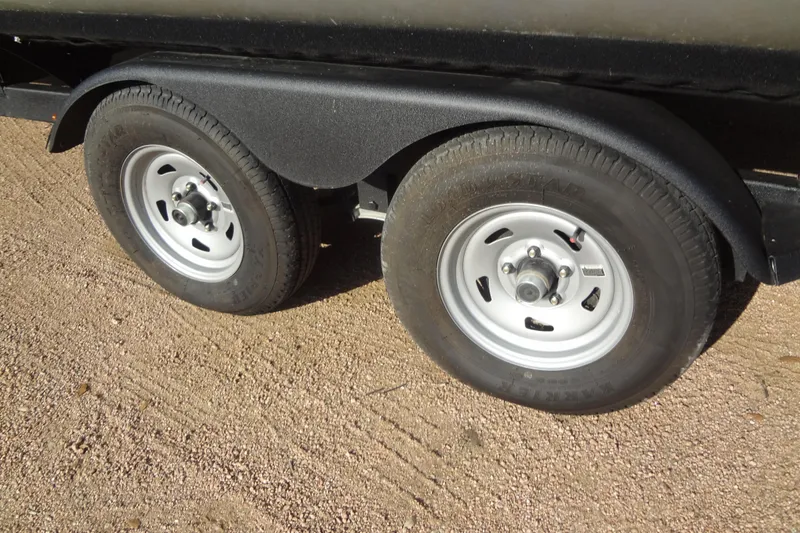 Slide: The Image of Trailer wheels of 2022 TRACKER MARINE Party Barge 24 DLX on gravel surface. - 50