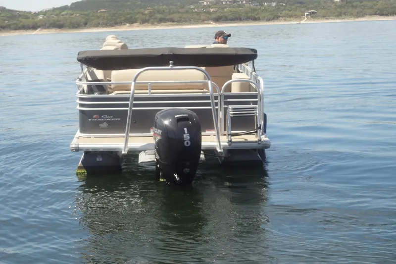 Slide: The Image of 2022 TRACKER MARINE Party Barge 24 DLX on water, rear view with Mercury 150 engine. - 7
