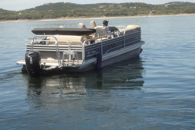 Slide: The Image of 2022 TRACKER MARINE Party Barge 24 DLX on a serene lake. - 8