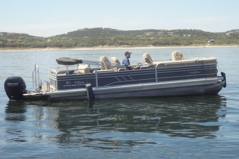 Slide: The Image of 2022 TRACKER MARINE Party Barge 24 DLX pontoon boat on calm water. - 9