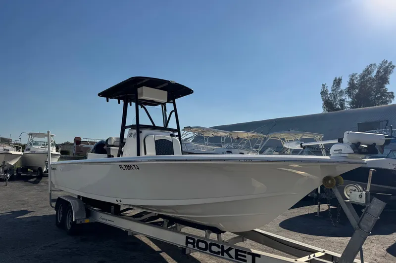 The Image of 2022 Tidewater 2410 Bay Max boat on trailer under clear sky. - 0