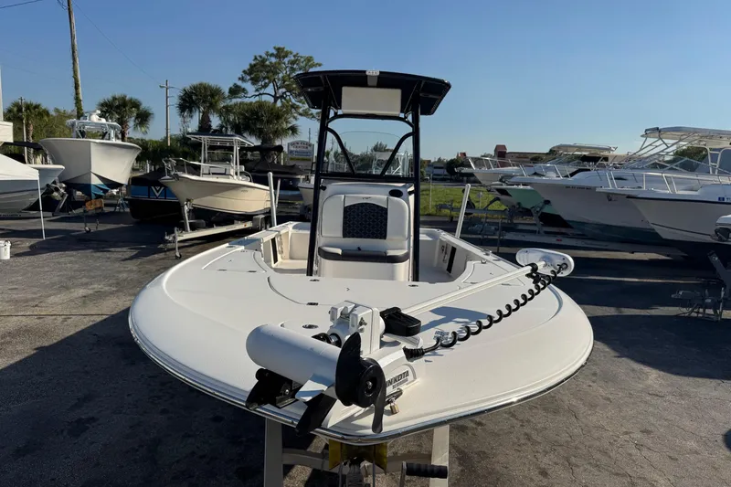 Slide: The Image of 2022 Tidewater 2410 Bay Max boat in a marina, surrounded by other vessels. - 1
