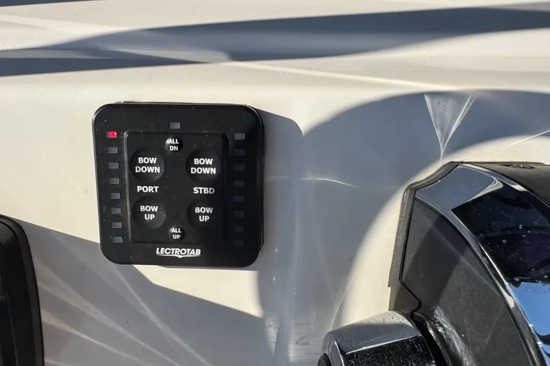 Slide: The Image of Control panel on a 2022 Tidewater 2410 Bay Max boat, featuring Lectrotab trim tab controls. - 13