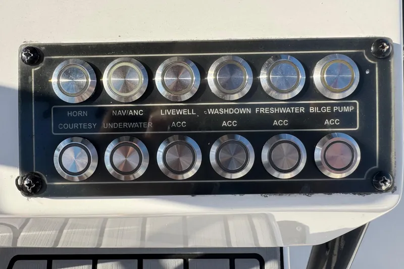 Slide: The Image of Control panel of a 2022 Tidewater 2410 Bay Max boat with labeled buttons. - 14