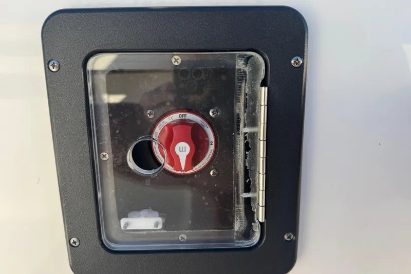 Slide: The Image of Battery switch on a 2022 Tidewater 2410 Bay Max boat, enclosed in a protective case. - 16