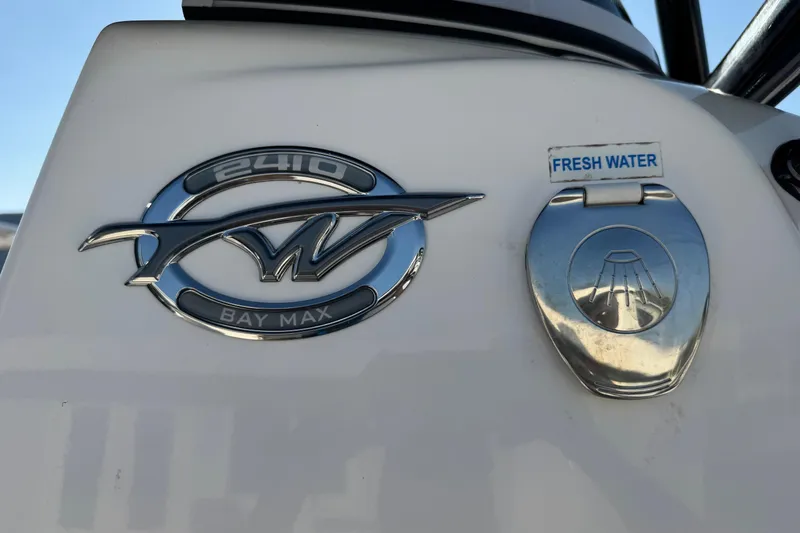 Slide: The Image of Tidewater 2410 Bay Max 2022 boat emblem and fresh water access panel. - 17