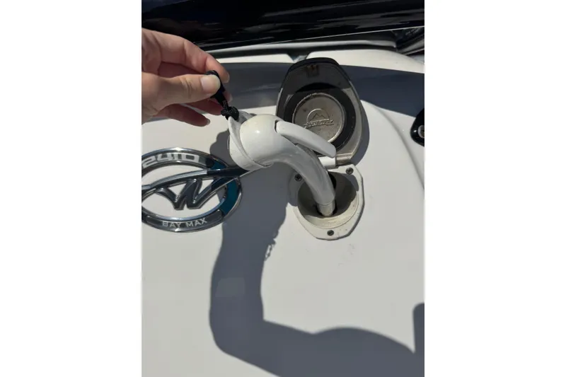 Slide: The Image of Hand holding fuel nozzle near Tidewater 2410 Bay Max boat fuel cap, 2022 model. - 18