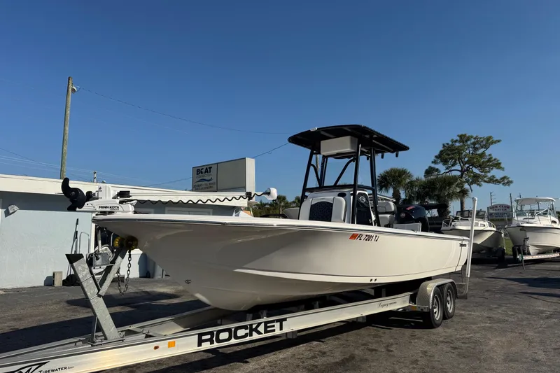 Slide: The Image of 2022 Tidewater 2410 Bay Max boat on trailer under clear blue sky. - 2
