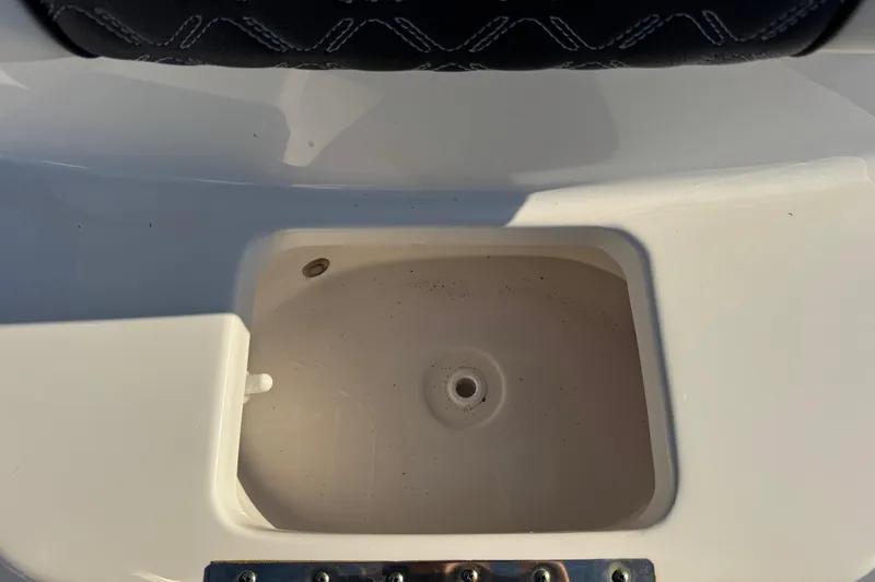 Slide: The Image of 2022 Tidewater 2410 Bay Max boat compartment detail, featuring a clean, white interior. - 21