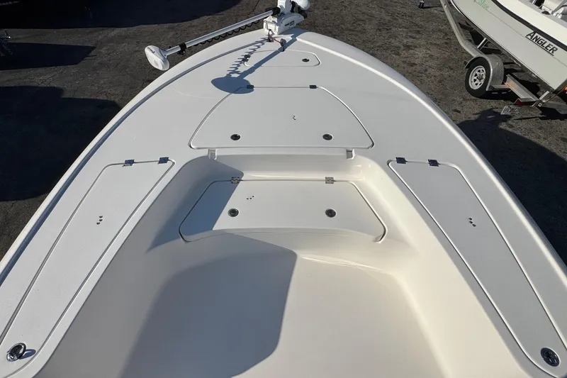 Slide: The Image of 2022 Tidewater 2410 Bay Max boat deck with storage compartments and trolling motor. - 22