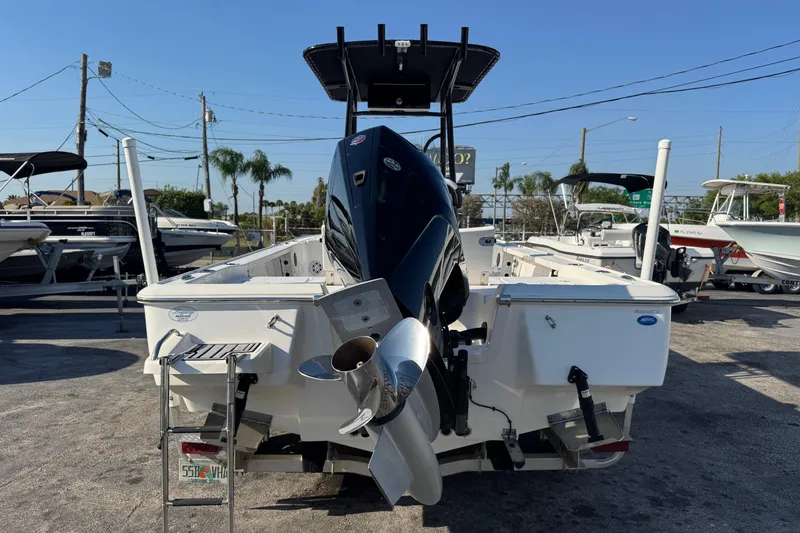 Slide: The Image of 2022 Tidewater 2410 Bay Max boat with powerful outboard motor, displayed in a marina setting. - 3