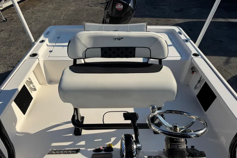 Slide: The Image of 2022 Tidewater 2410 Bay Max boat interior with steering wheel and seating. - 31